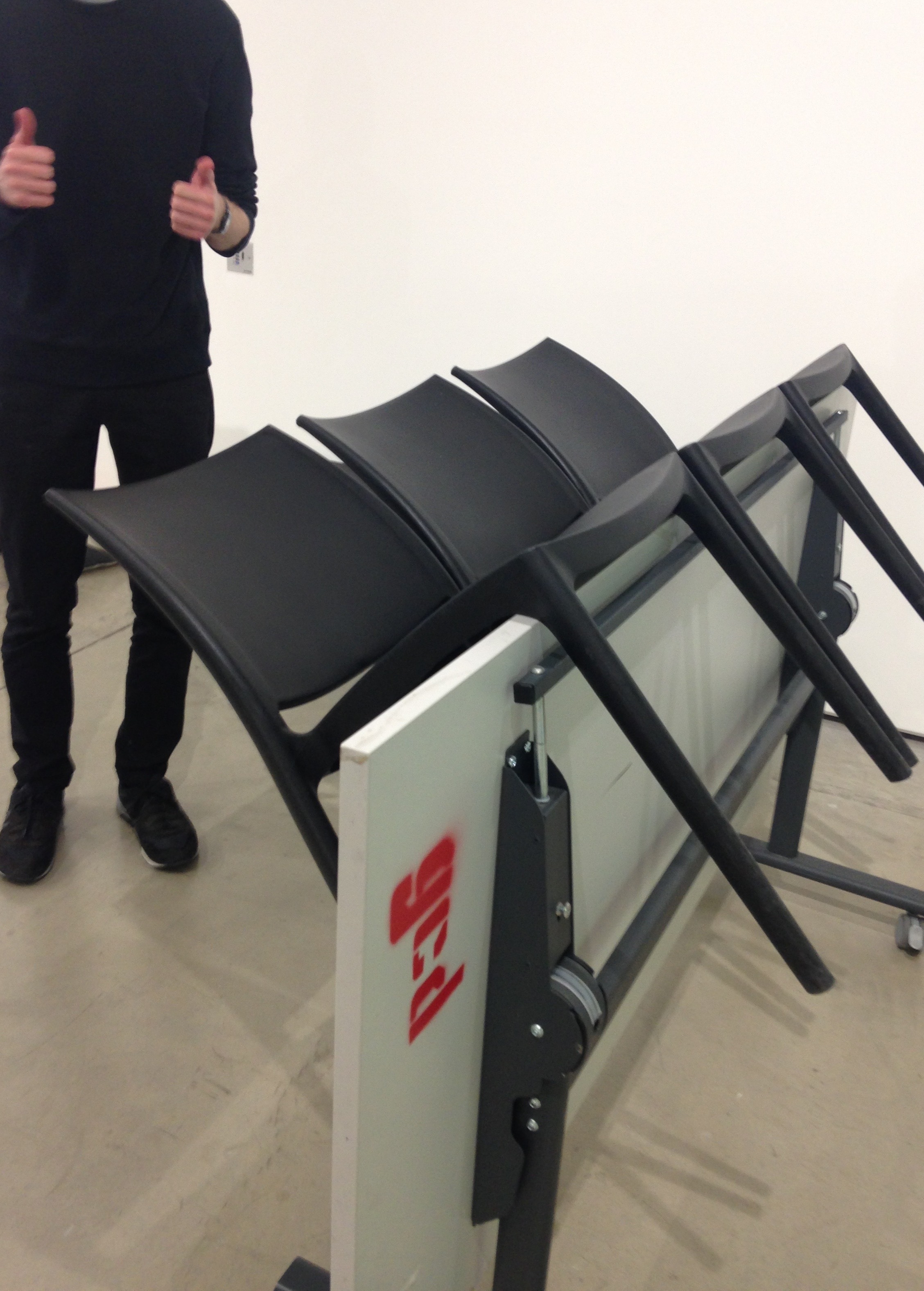 Three chairs balanced on a folded table